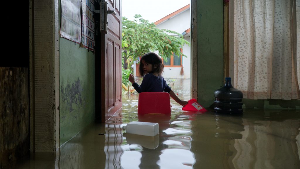 A little girl sat at the door of the house when it was hit by a flood